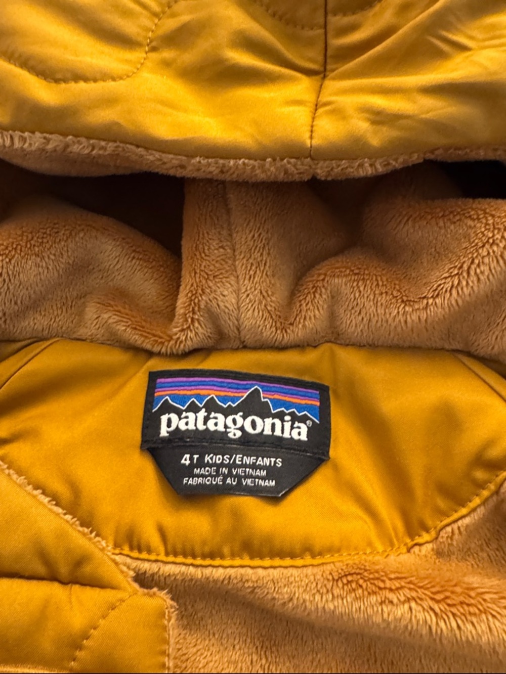 Patagonia kids' puffer jacket in mustard yellow